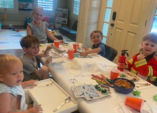 children sitting at table celebrating Passover with activities